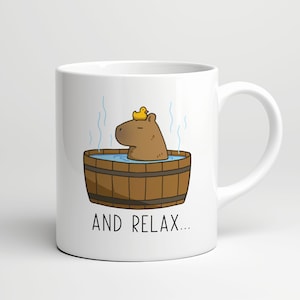 May include: White ceramic mug with a cartoon illustration of a capybara in a wooden hot tub with a yellow rubber ducky on its head. The text "AND RELAX..." is printed below the image.