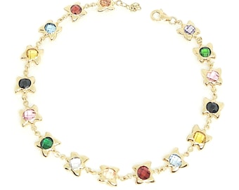 May include: A gold chain bracelet featuring a series of star-shaped settings, each containing a faceted gemstone in various colors including red, blue, yellow, green, black, and pink, secured with a lobster claw clasp.
