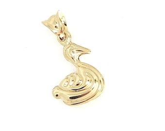 May include: A polished gold pendant shaped like a swimming swan or goose, featuring a smooth, reflective surface and a small triangular bail at the top for attachment to a chain. The design captures the bird in a graceful, curved posture.