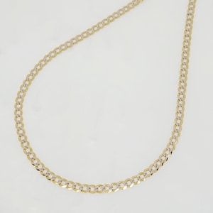May include: A gold and silver-tone curb chain necklace. The chain is composed of interlocking oval links, with alternating gold and silver-colored segments. The necklace is displayed against a white background, highlighting its design and color contrast.