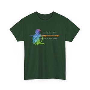 May include: A dark green t-shirt with a colorful graphic of a person holding a spear. The text "Leonard Bernstein American Conductor" is printed on the shirt.