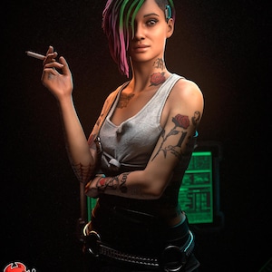 May include: A woman with vibrant green, pink, and purple hair, wearing a gray tank top and black pants. She has multiple tattoos, including roses and the number 1. She is holding a cigarette. The image has a dark background.