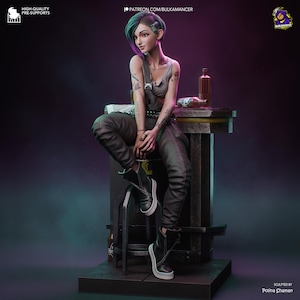 May include: A detailed figurine of a woman with tattoos, wearing a gray tank top, black overalls, and black boots. She is seated on a stool next to a small table with a bottle and a newspaper. The figurine has green and purple hair.