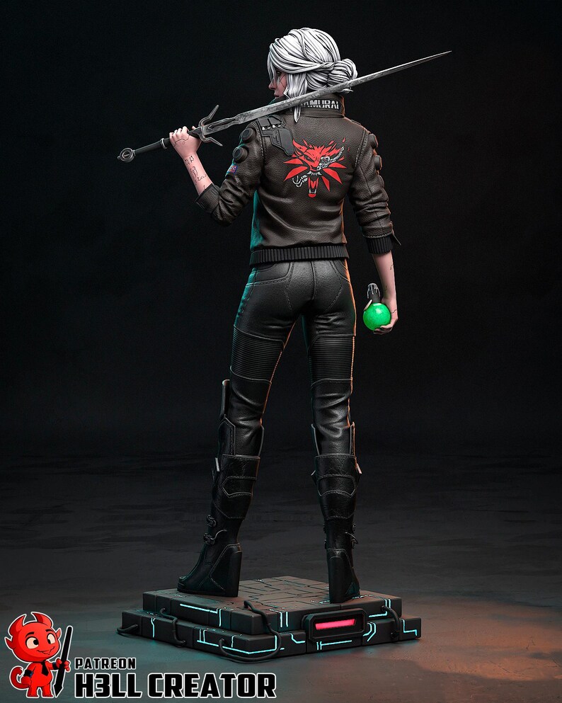 May include: A detailed figurine of a character from The Witcher series. The figure is wearing a black leather jacket with a red emblem on the back, black pants, and boots. She holds a sword and a green orb. The figure stands on a platform.