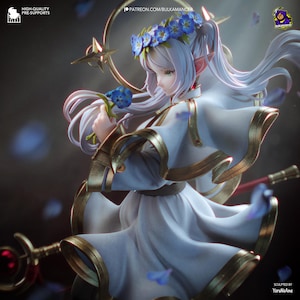 May include: A fantasy figurine of an elf with long white hair, wearing a white dress with gold trim and a blue flower crown. The figure holds a blue flower and a staff with a red gem, surrounded by floating blue petals and a golden halo.