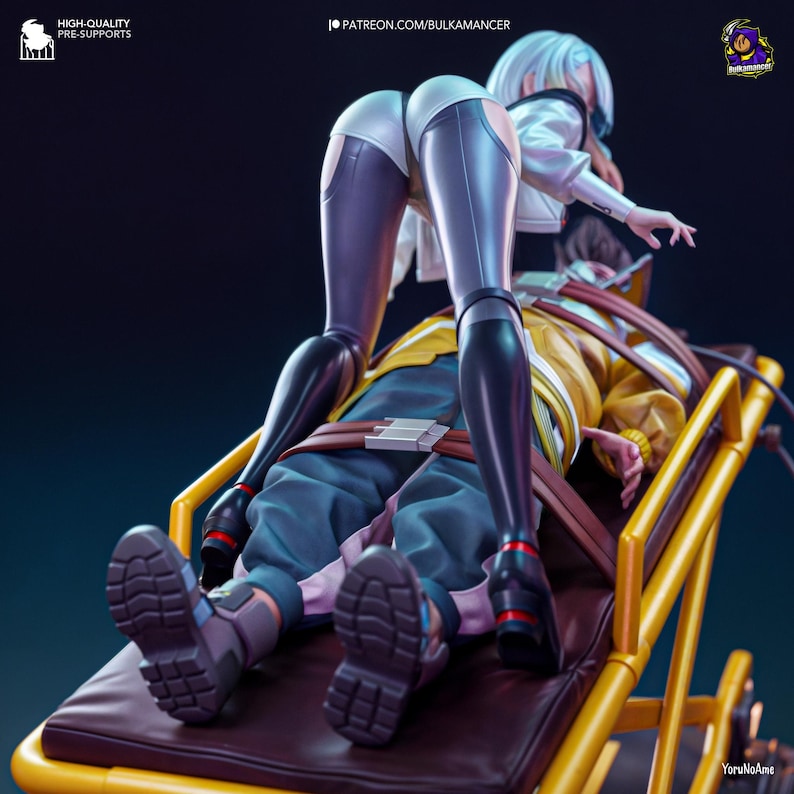 May include: A detailed figurine featuring two characters. One figure is standing, wearing white shorts and black leggings, and a white jacket. The other figure is lying down on a yellow stretcher, wearing a yellow jacket and blue pants. The image has text that reads "HIGH-QUALITY PRE-SUPPORTS" and "PATREON.COM/BULKAMANCER".