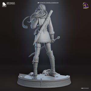 May include: A gray 3D printed resin figurine of a warrior standing on a circular base. The figure has long hair, wears a tunic with fur trim, pants, and tall boots. A sword in a scabbard is strapped to the back, and a hand is held at the side.