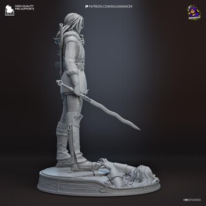 May include: A gray 3D printed resin figurine of a standing warrior with long hair, wearing a fur-collared tunic and tall boots. The figure holds a wavy sword and stands on a circular base featuring a partially submerged figure in the ground.