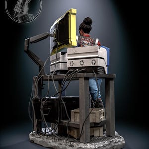 May include: A detailed figurine of a person seated at a computer workstation. The figure is wearing a jacket with text on the back. The workstation includes a monitor with a yellow frame, multiple computer components, and a network of cables. The base is a textured, gray surface.