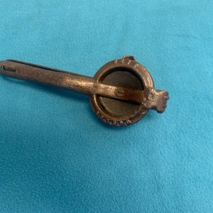 May include: A vintage cast iron citrus juicer with a handle and a round pressing surface. The juicer has the words "The Victor" embossed on the side.