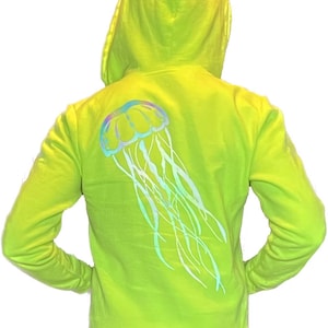 May include: A bright yellow hoodie with a reflective iridescent jellyfish design on the back.
