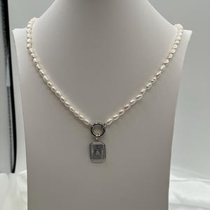 Rice pearls and sunburst pendant necklace.