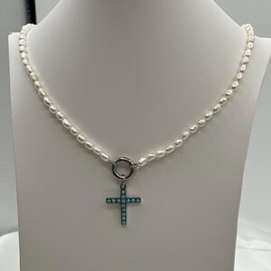 Rice pearls and cross pendant necklace and earring set.