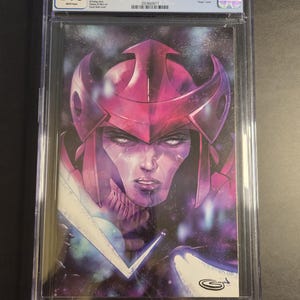 May include: A graded comic book, "We Only Find Them When They're Dead #1", with a 9.8 grade. The cover art depicts a purple and pink character with a helmet, set against a cosmic backdrop. The comic is in a clear protective case.