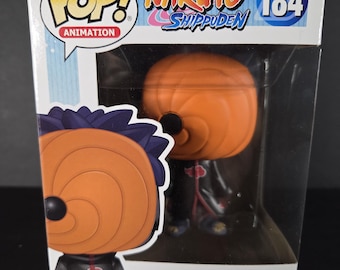 May include: A Funko Pop! Animation figure of Tobi from Naruto Shippuden, number 184. The figure is in a box with the Pop! Animation logo and the Naruto Shippuden logo. The figure is orange and black.