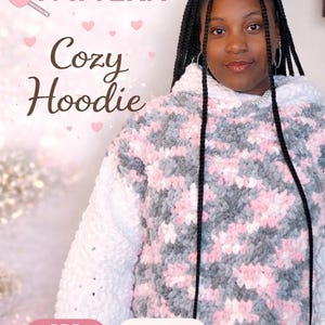 May include: A cozy crochet hoodie in white, gray, and pink. The image includes the text "CROCHET PATTERN" and "Cozy Hoodie". The design is described as "BEGINNER FRIENDLY" and available as a "PDF TUTORIAL".