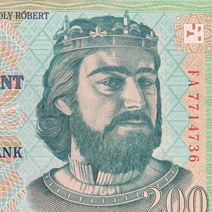May include: A Hungarian 200 forint banknote featuring a portrait of Károly Róbert, a king with a crown and beard. The note has the text "KÉTSZÁZ FORINT" and "MAGYAR NEMZETI BANK". The note is green, blue, and brown.