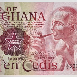 May include: A ten Cedis banknote from the Bank of Ghana, featuring a portrait of a man smoking a pipe. The note is predominantly red and white, with the text "BANK OF GHANA" and the number "10" prominently displayed.