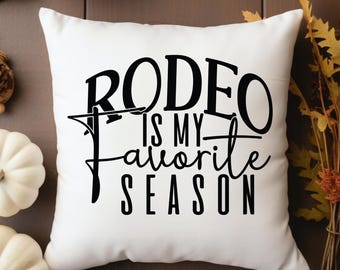 May include: White throw pillow with black text that reads "Rodeo is my favorite season".