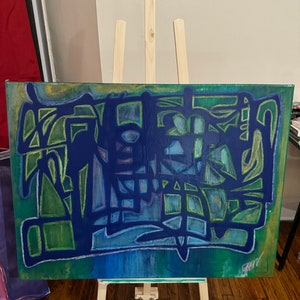 May include: Abstract painting on canvas, featuring a vibrant mix of blues, greens, and yellow-green hues. The artwork displays geometric shapes and lines, with a signature in the lower right corner. The canvas is displayed on a wooden easel.