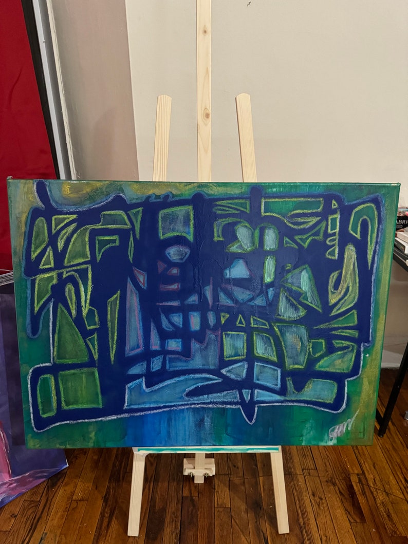 May include: Abstract painting on canvas, featuring a vibrant mix of blues, greens, and yellow-green hues. The artwork displays geometric shapes and lines, with a signature in the lower right corner. The canvas is displayed on a wooden easel.
