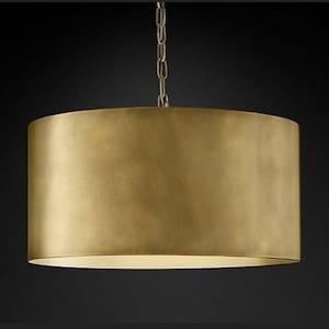 May include: A large, round, gold-toned pendant light fixture with a brushed metal finish.
