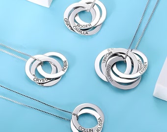 May include: Silver interlocking circle necklace with multiple names engraved on each ring. The names are:  GRAY, CAMILIA, ROGER, CRYSTAL, ROBIN, MICHAEL, ELIZABETH, BRANDY, LINDSEY, COLLIN, MELISSA.