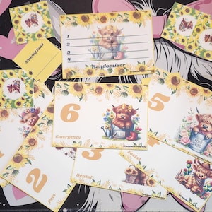 May include: A set of 10 yellow and white cards with a sunflower border. Each card features a cute cartoon Highland cow with a different number from 1 to 6 and a word like "Emergency", "Dental", "Pets", "Facial", "Randomizer", and "Sinking Fund".