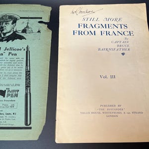 K&ouml;nnte beinhalten: Zwei alte Papierartikel: eine gr&uuml;n-wei&szlig;e Werbung f&uuml;r "Jellicoe's Pen" und ein Buch mit dem Titel "Still More Fragments From France" von Captain Bruce Bairnsfather. Das Buch ist Band III, ver&ouml;ffentlicht in London.