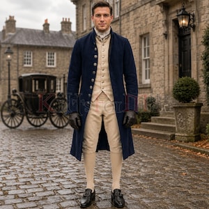 May include: A navy blue long coat worn over a beige waistcoat and matching knee-length breeches. The ensemble includes a white cravat, black leather gloves, and black buckled shoes. The coat features a row of silver buttons down the front.