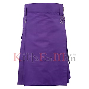 May include: A solid purple kilt with a pleated design. The kilt features metal hardware, including buckles and rings, and a structured waistband. The text "Kilts For Men Store" is visible at the bottom of the kilt.