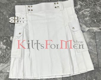 May include: White utility kilt with multiple pockets and silver buckles. The kilt has a pleated design and is made of a lightweight fabric.