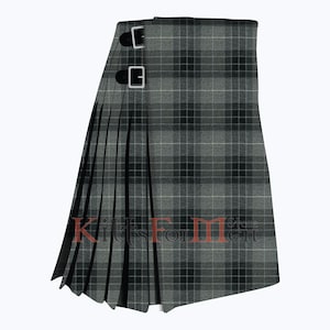 May include: A gray and black tartan kilt with a black leather strap and buckle. The kilt is pleated and has a fringed edge. The text "Kilts For Men" is visible on the kilt.