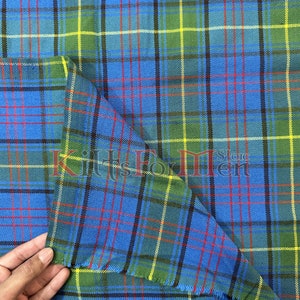 May include: A close-up of a blue, green, yellow, and red tartan fabric. The fabric is folded in half and has a fringed edge. The text "Kilts For Men" is visible in the image.