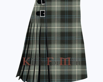 May include: A green, white, and blue plaid kilt with black buckles. The kilt is pleated and has a  "Kilts For Men" store logo.