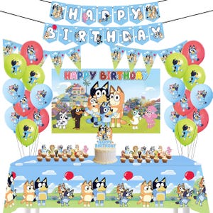 May include: Blue and green birthday party decorations with a 'Happy Birthday' banner, balloons, and a table setting featuring a cake and cupcakes. The theme is 'Bluey' with images of the cartoon characters on the decorations and table setting.