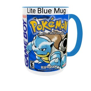 May include: A ceramic mug with a bright blue handle and rim, featuring a graphic print of the Pok&eacute;mon Blue Version Game Boy game box art. The design includes the Pok&eacute;mon logo, the character Blastoise, and the text Lite Blue Mug at the top.
