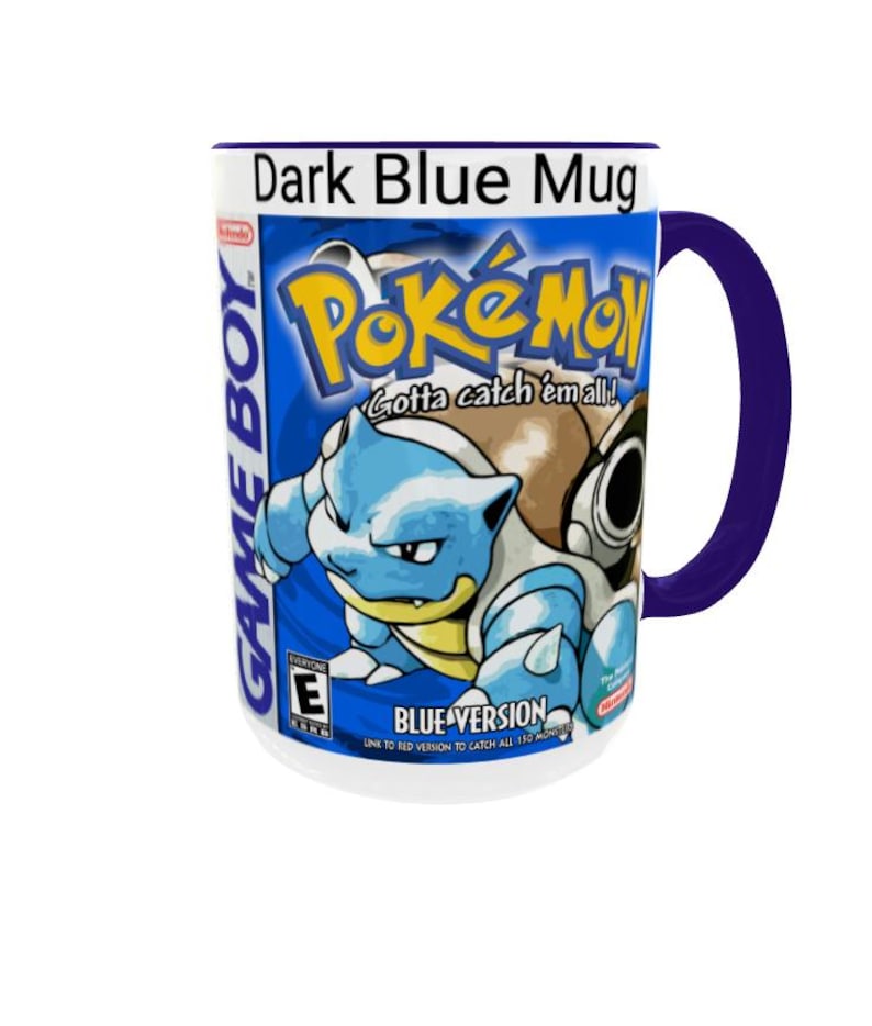 May include: A dark blue ceramic mug featuring a graphic print of the Pok&eacute;mon Blue Version Game Boy video game cover art. The design includes the Pok&eacute;mon Blastoise, the Pok&eacute;mon logo, the text Game Boy, and the ESRB rating E for everyone.