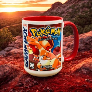 May include: White ceramic mug with a red interior and handle, featuring a Pokémon design. The mug showcases Charizard and the text "Pokémon Gotta catch 'em all!" and "Red Version" on a Game Boy-style label.