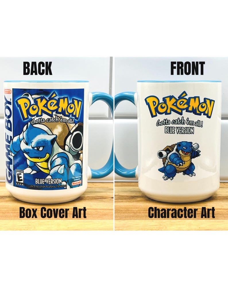 May include: A white ceramic mug with a blue handle and interior rim. One side features the Pok&eacute;mon Blue Version Game Boy box art with Blastoise. The other side displays the Pok&eacute;mon logo, the text Blue Version, and a pixelated Blastoise character.