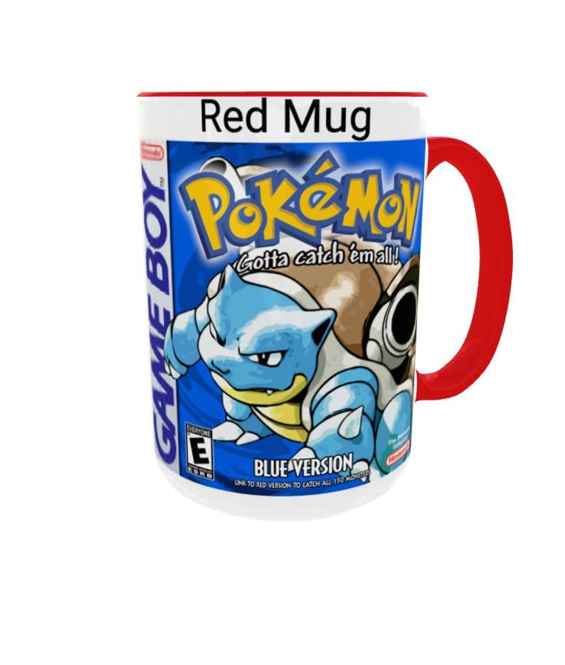 May include: A white ceramic mug with a bright red handle and rim, featuring a graphic print of the Pok&eacute;mon Blue Version Game Boy game cover. The design includes the Pok&eacute;mon logo, the text Gotta catch 'em all!, Blastoise, and the ESRB E rating.