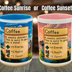May include: Two ceramic coffee mugs with the text "Coffee Sunrise or Coffee Sunset!" Each mug features a colorful design with the word "Coffee" and a description of its benefits. One mug has a blue handle and rim, the other has a pink handle and rim.