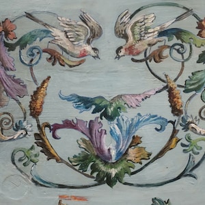 May include: A decorative painting featuring two birds with intricate floral designs in shades of green, purple, blue, and gold on a light blue background.
