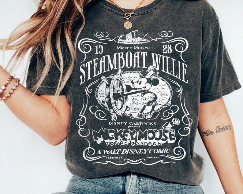 a woman wearing a steamboat willie t - shirt