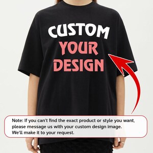 A person wearing a black t-shirt with the text "CUSTOM YOUR DESIGN" printed on it.