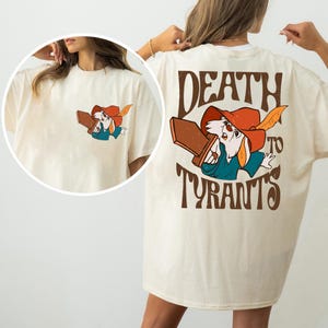 a woman wearing a t - shirt with a cartoon character on it