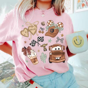 a woman in a pink shirt holding a coffee mug