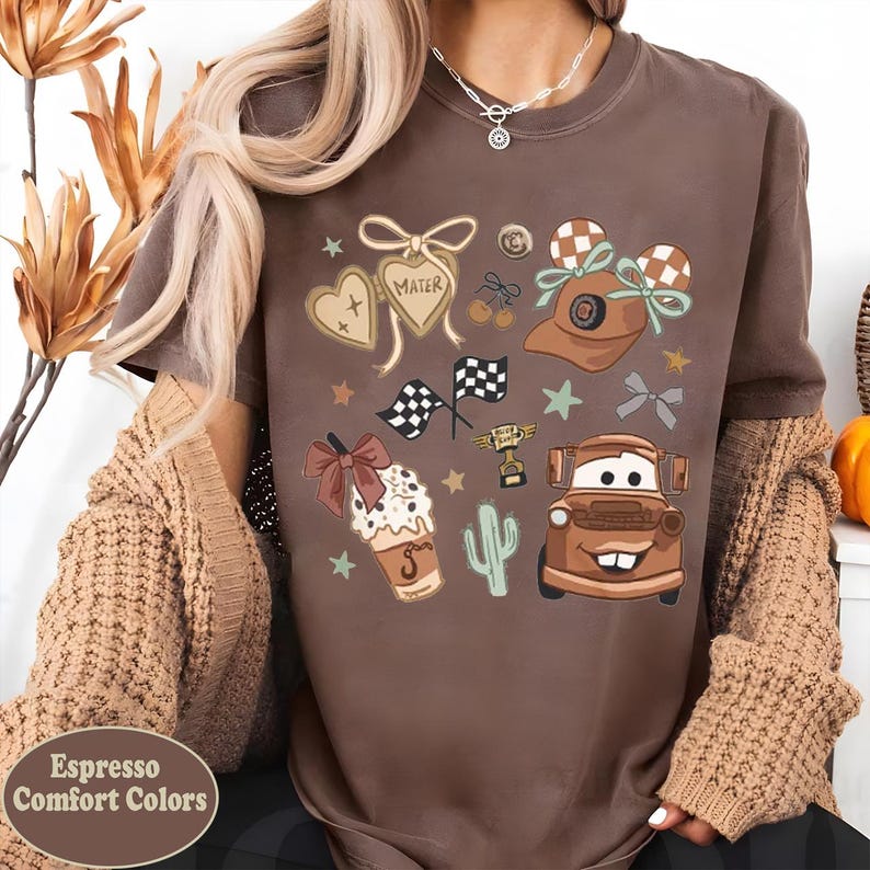 a woman wearing a brown shirt with cars on it