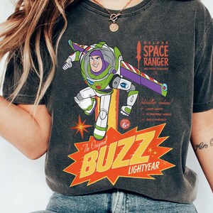 a woman wearing a buzz lightyear space ranger t - shirt