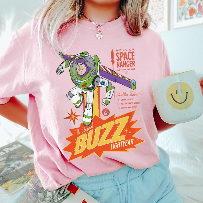 a woman wearing a pink buzz lightyear shirt